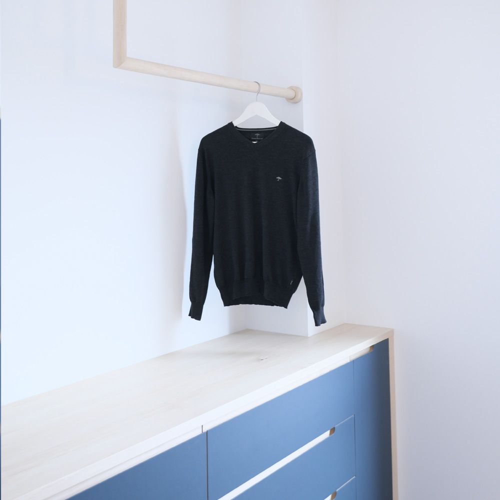 Blaues Sideboard mit integrierter Holz-Kleiderstange als Garderobenlösung